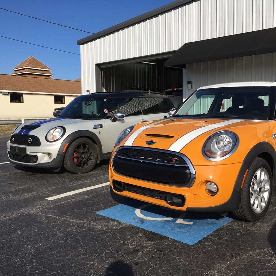 mini coopers in front of heads up automotive